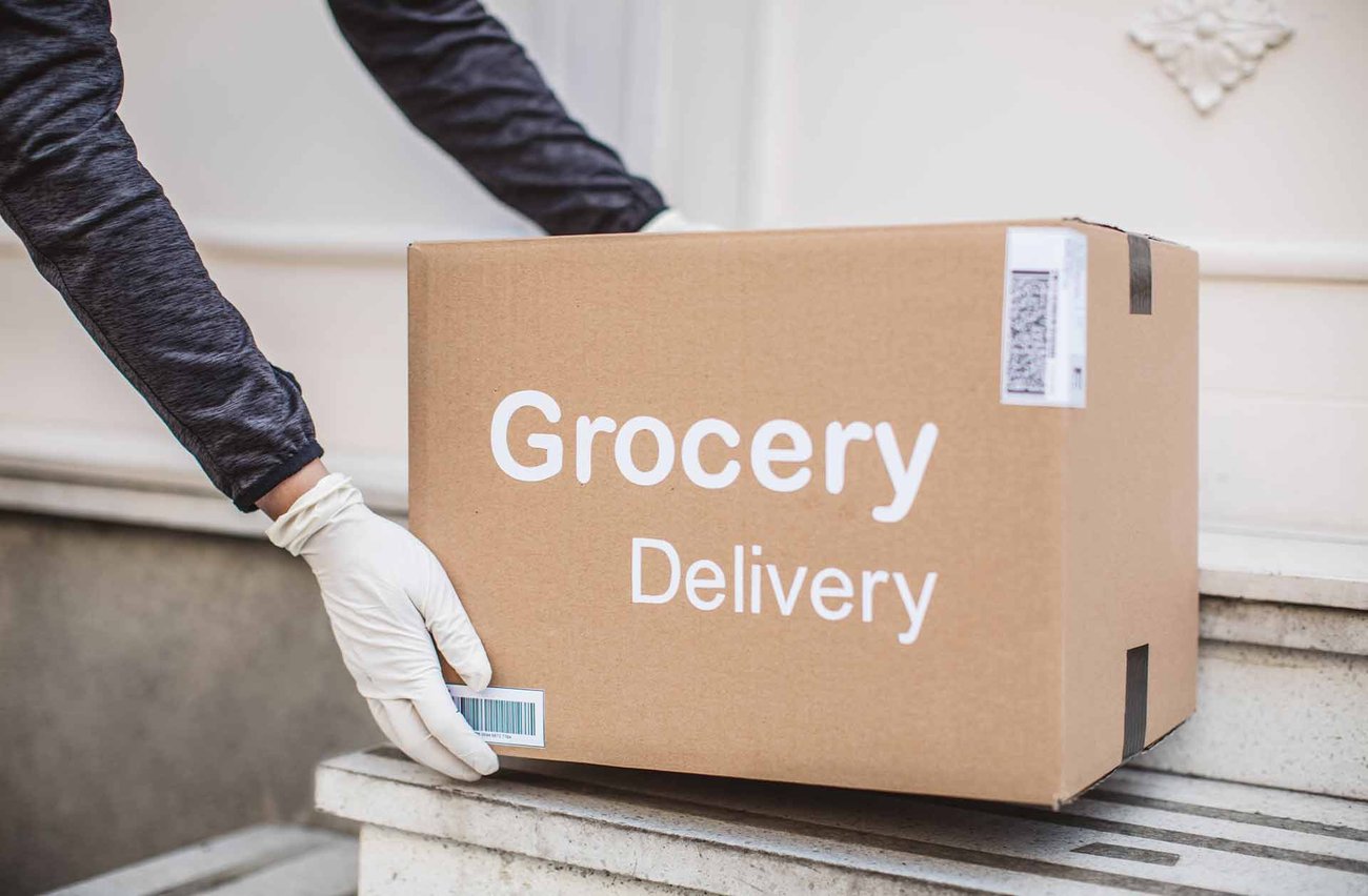 Grocery delivery box being placed on steps