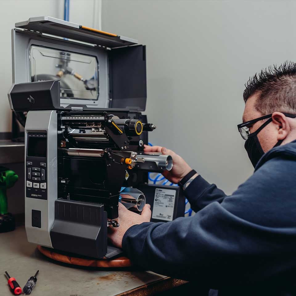 vms_employee_fixing_zebra_barcode_printer