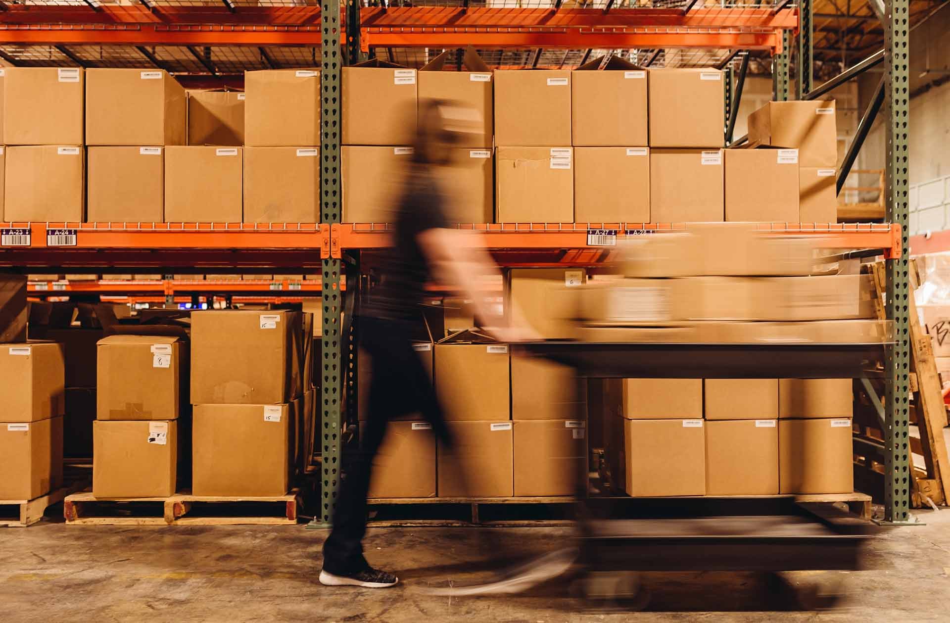 warehouse_worker_pushing_cart_quickly