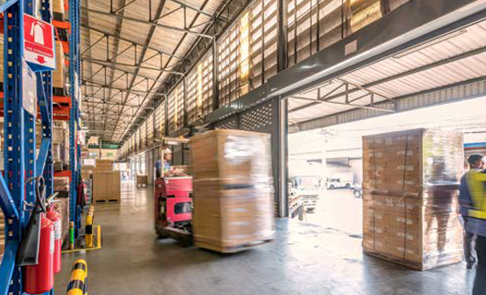 pallet jacks moving cargo in a warehouse