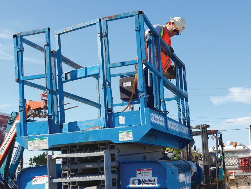 Worker in scissor lift