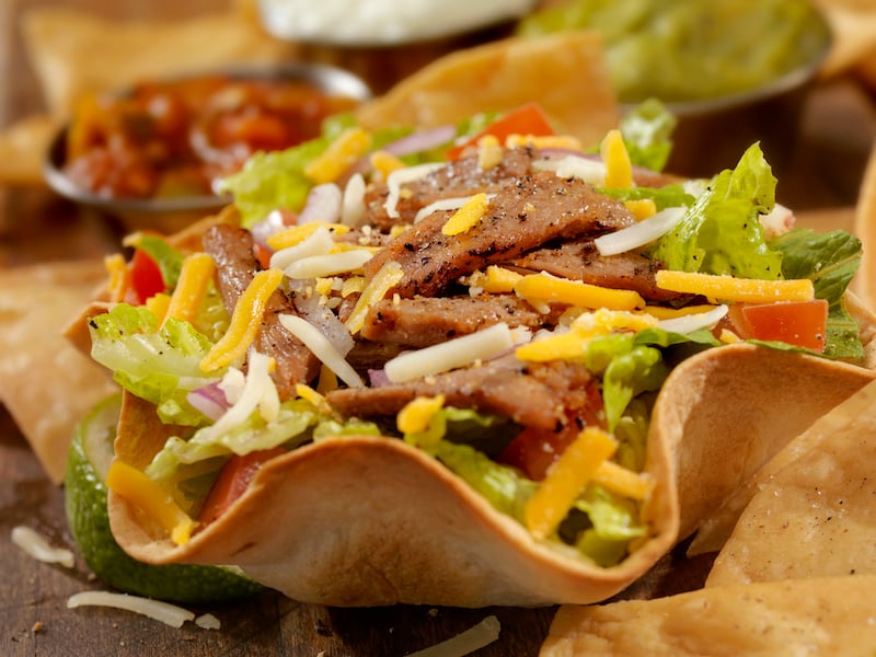 Taco salad in hard tortilla bowl