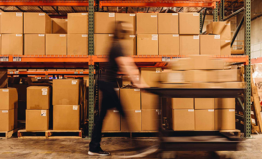 warehouse_worker_pushing_cart_quickly