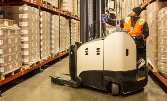 worker_using_forklift_in_cold_storage_warehouse