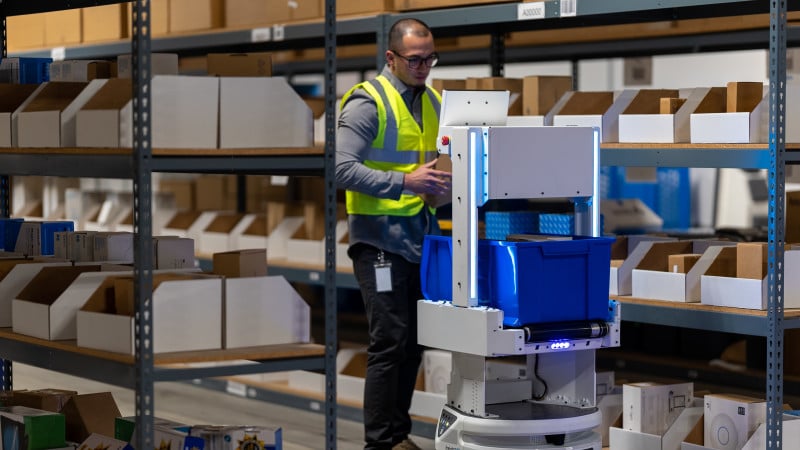 Rendering of an autonomous mobile robot being loaded by a worker